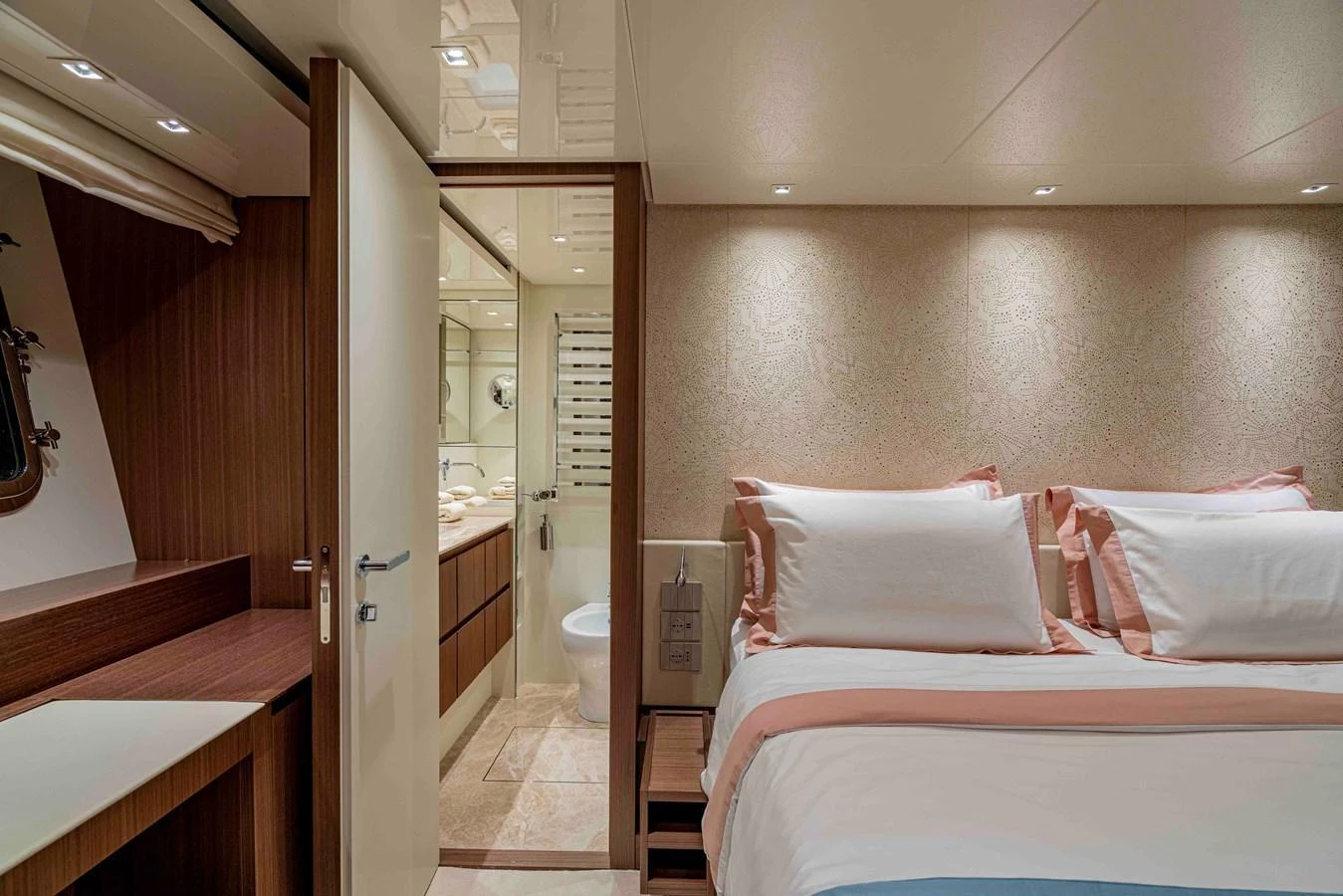 A cozy guest stateroom featuring a double bed and an ensuite bathroom. aboard FIREFLY Yacht for Sale