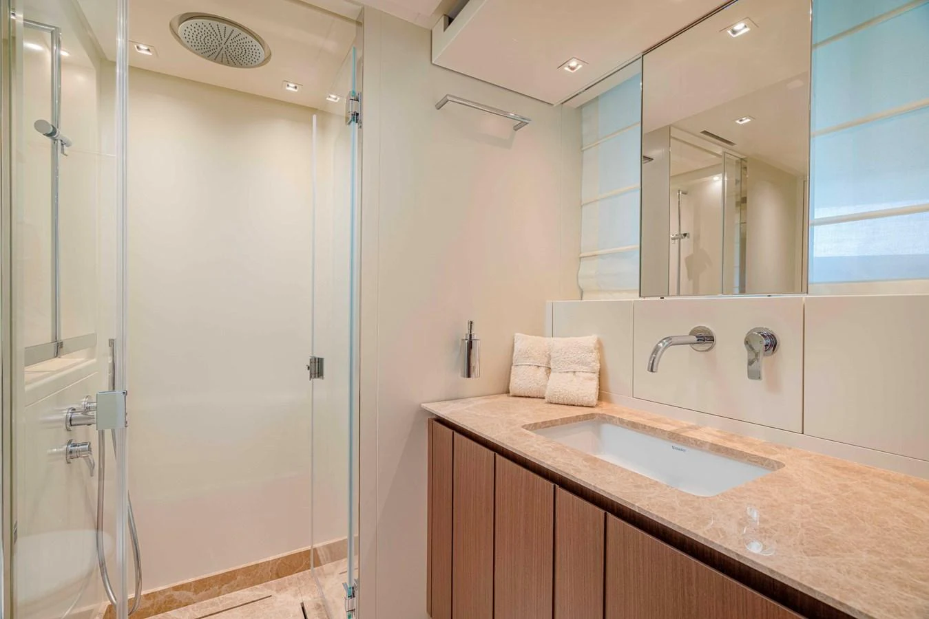 The yacht's bathroom features a sleek design with modern fixtures and a spacious shower area. aboard FIREFLY Yacht for Sale
