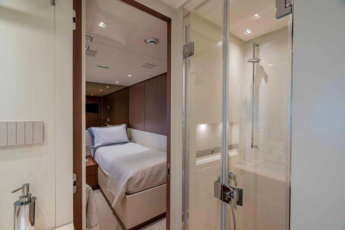 The guest stateroom offers a cozy and elegant sleeping area with an ensuite bathroom. aboard FIREFLY Yacht for Sale