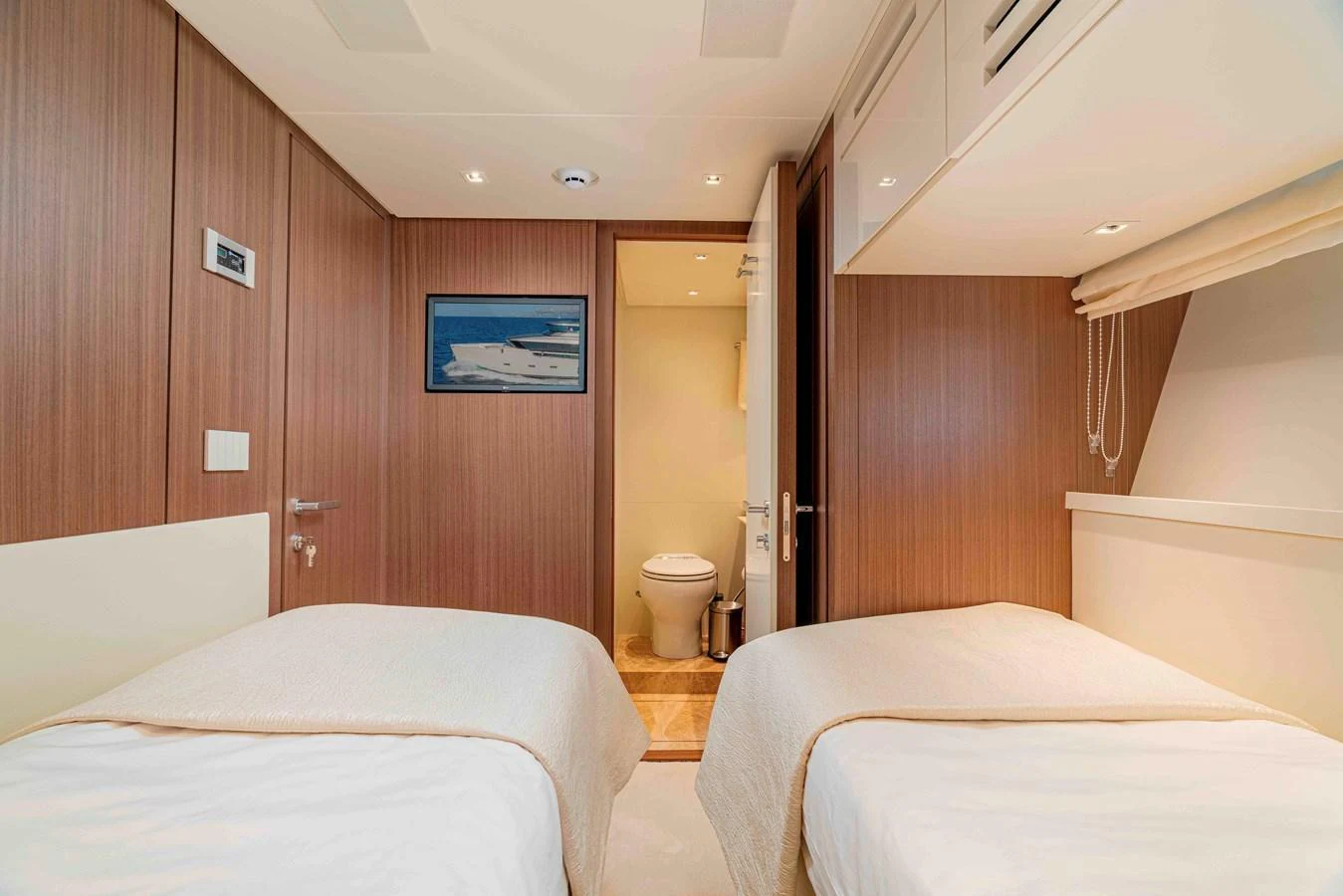 The guest stateroom features twin beds and a private ensuite bathroom, offering comfort and privacy. aboard FIREFLY Yacht for Sale