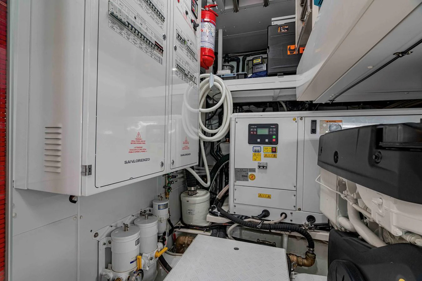 The image showcases the well-organized engine room with various control panels and equipment. aboard FIREFLY Yacht for Sale