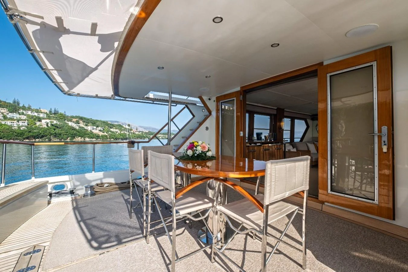 The aft deck features a stylish dining area with a beautiful view of the water. aboard STALCA Yacht for Sale