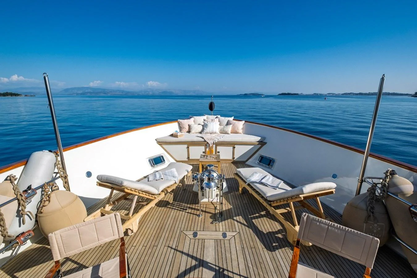 The foredeck offers a serene lounging area with sunbeds and a stunning ocean view. aboard STALCA Yacht for Sale