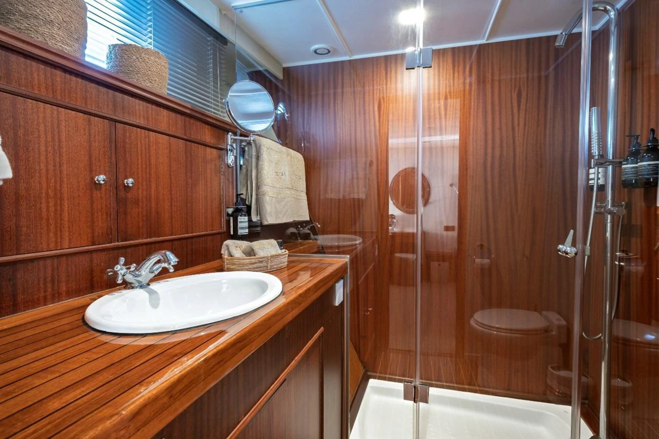 The yacht's bathroom features elegant wood paneling and modern fixtures. aboard STALCA Yacht for Sale