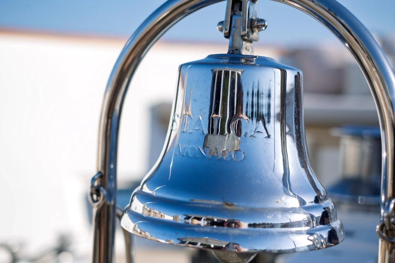 A polished chrome ship's bell with elegant engravings is mounted on the yacht. aboard STALCA Yacht for Sale