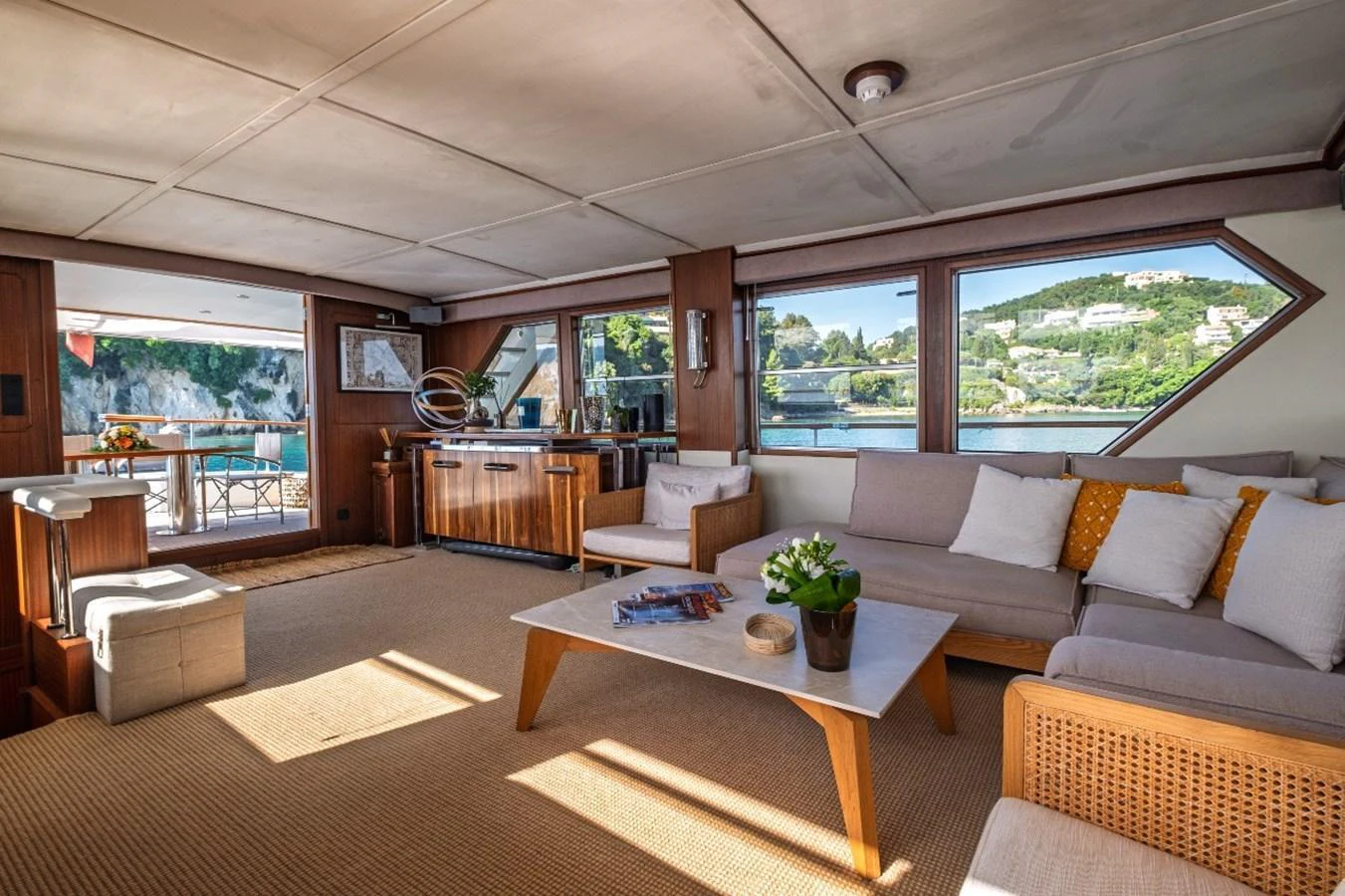 The salon offers a spacious and comfortable seating area with large windows providing scenic views. aboard STALCA Yacht for Sale