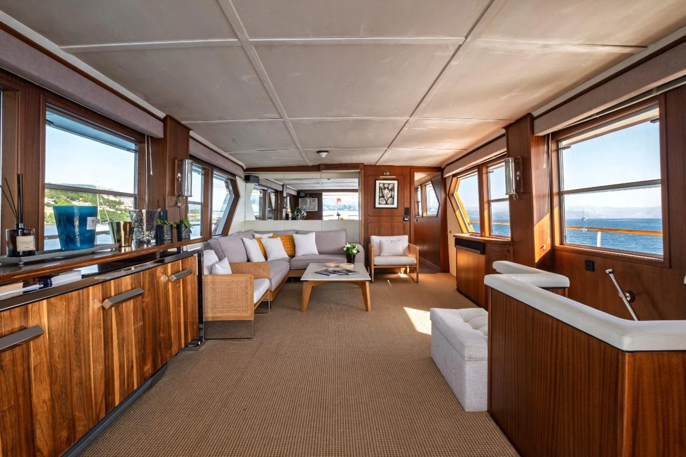 The yacht's salon features a spacious and elegant seating area with panoramic windows offering stunning ocean views. aboard STALCA Yacht for Sale