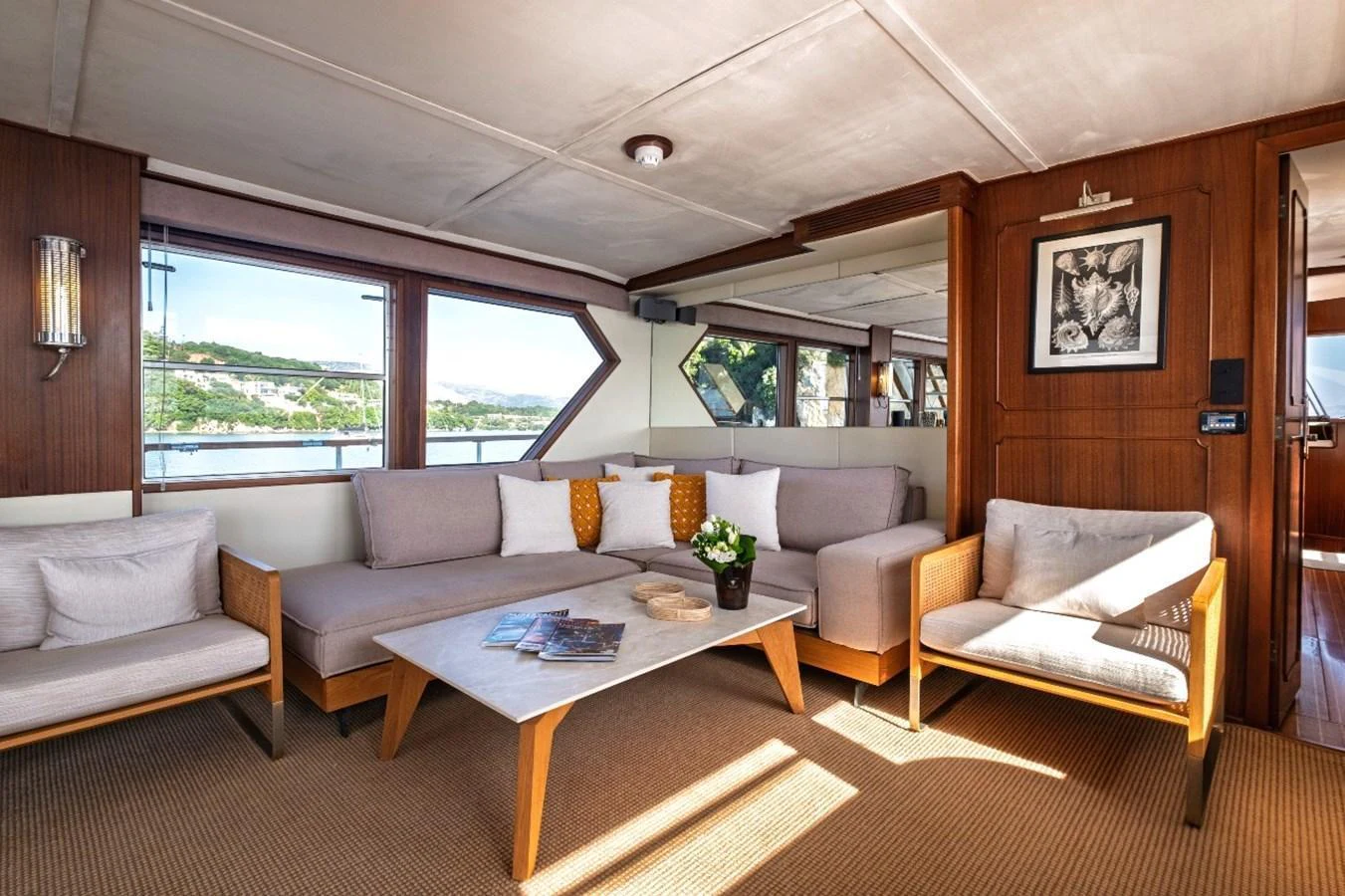 The salon features a spacious seating area with large windows offering scenic views. aboard STALCA Yacht for Sale