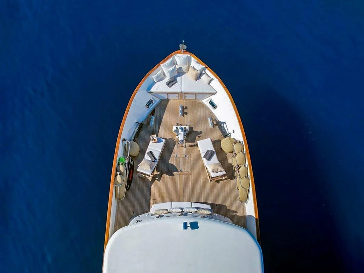 The foredeck features a spacious lounging area with sunbeds and seating, perfect for relaxation. aboard STALCA Yacht for Sale