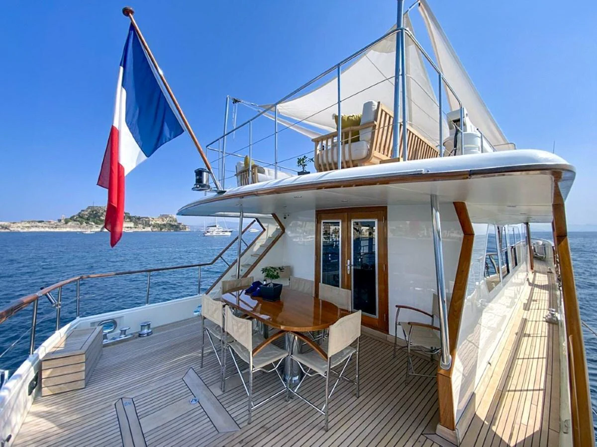 The aft deck features a spacious dining area with a beautiful view of the surrounding waters. aboard STALCA Yacht for Sale