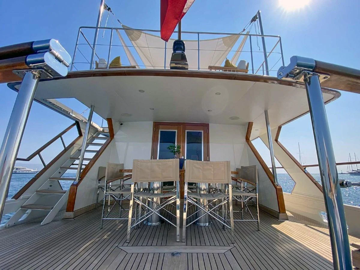 The aft deck features an elegant dining area with a view of the sea. aboard STALCA Yacht for Sale