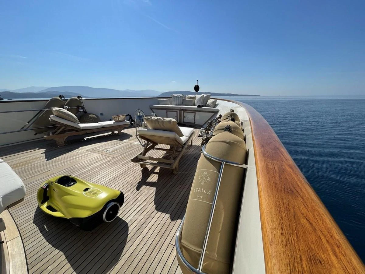 The yacht's deck offers a serene and spacious area with luxurious sun loungers and a beautiful view of the sea. aboard STALCA Yacht for Sale