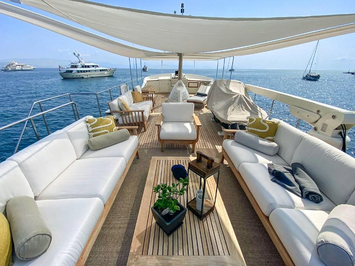 The sundeck offers a luxurious outdoor lounging area with comfortable seating and scenic ocean views. aboard STALCA Yacht for Sale
