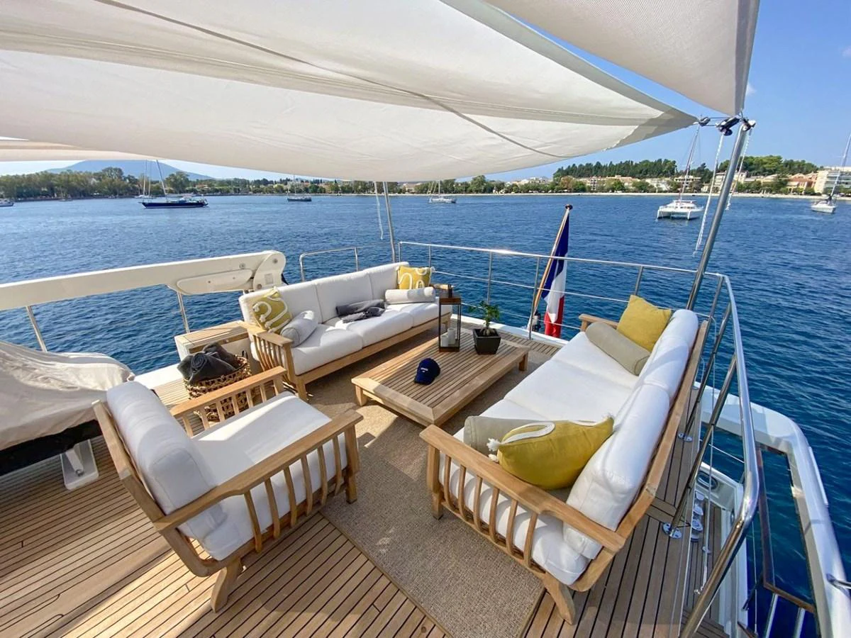 The aft deck features a stylish and comfortable seating area with a scenic view of the water. aboard STALCA Yacht for Sale