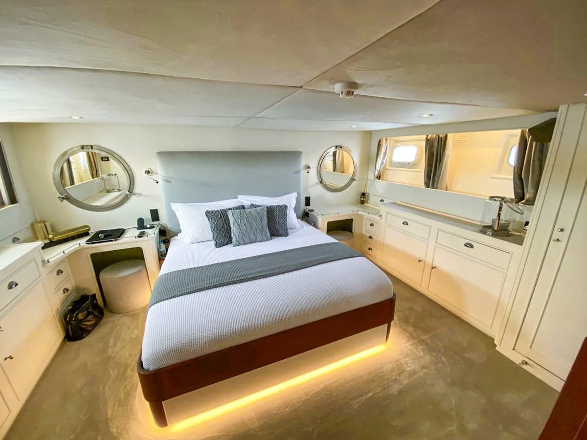 A luxurious stateroom featuring a comfortable bed with elegant bedding and ample storage space. aboard STALCA Yacht for Sale