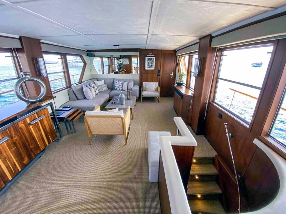 The yacht's salon features a spacious and elegant seating area with large windows offering panoramic views. aboard STALCA Yacht for Sale