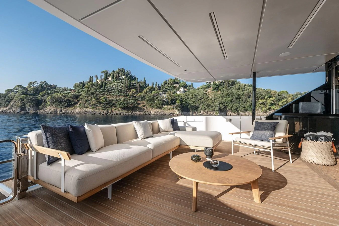 The aft deck features a spacious seating area with a stunning view of the surrounding landscape. aboard INFYNITO 80 Yacht for Sale