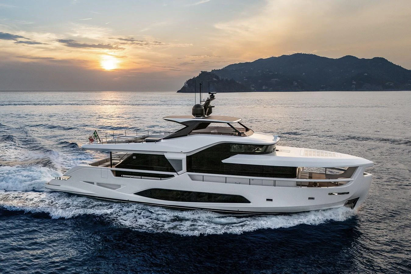 A sleek and modern yacht cruises through calm waters at sunset, showcasing its elegant design and luxurious features. aboard INFYNITO 80 Yacht for Sale