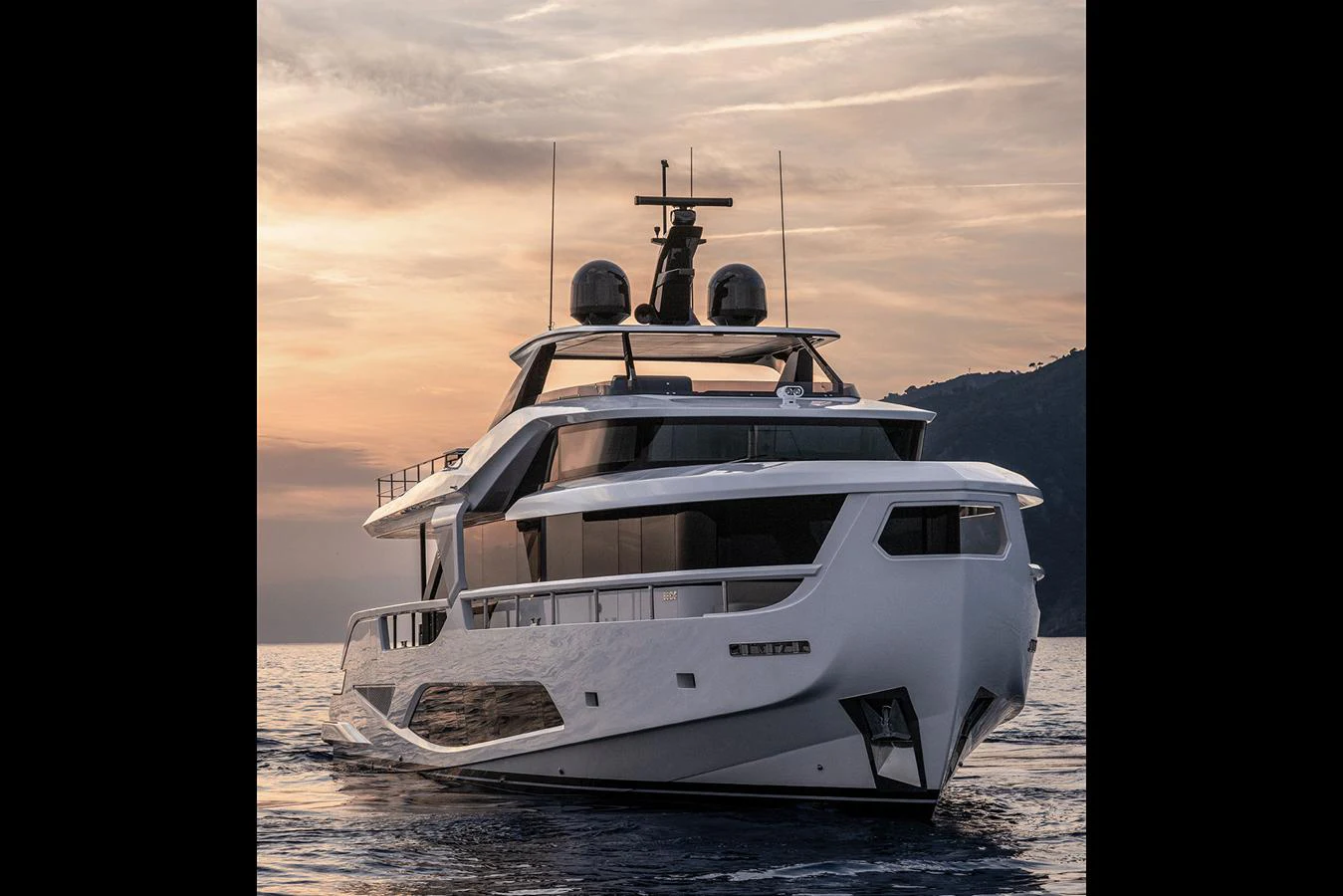 A sleek and modern yacht cruises gracefully on calm waters at sunset. aboard INFYNITO 80 Yacht for Sale