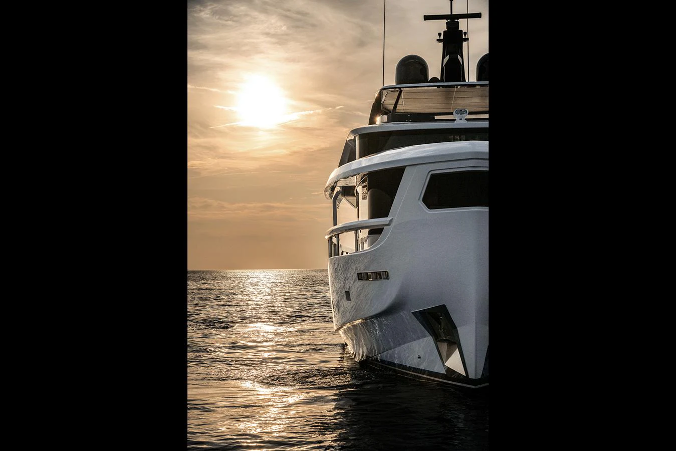 A luxurious yacht is captured at sunset, showcasing its sleek design and elegant lines against the serene water. aboard INFYNITO 80 Yacht for Sale