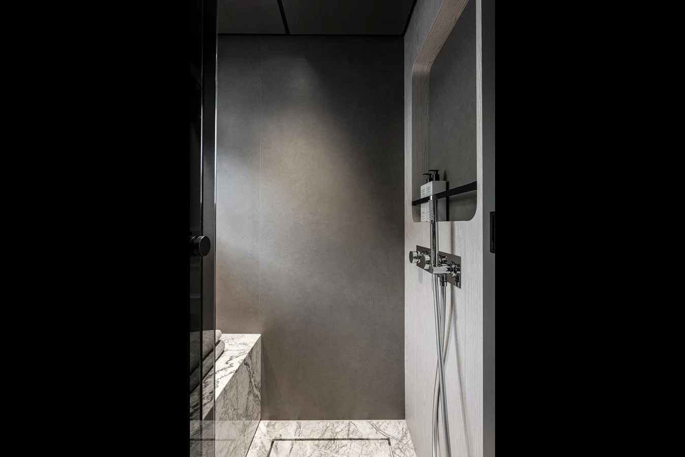 A sleek and modern yacht bathroom featuring a luxurious marble shower. aboard INFYNITO 80 Yacht for Sale
