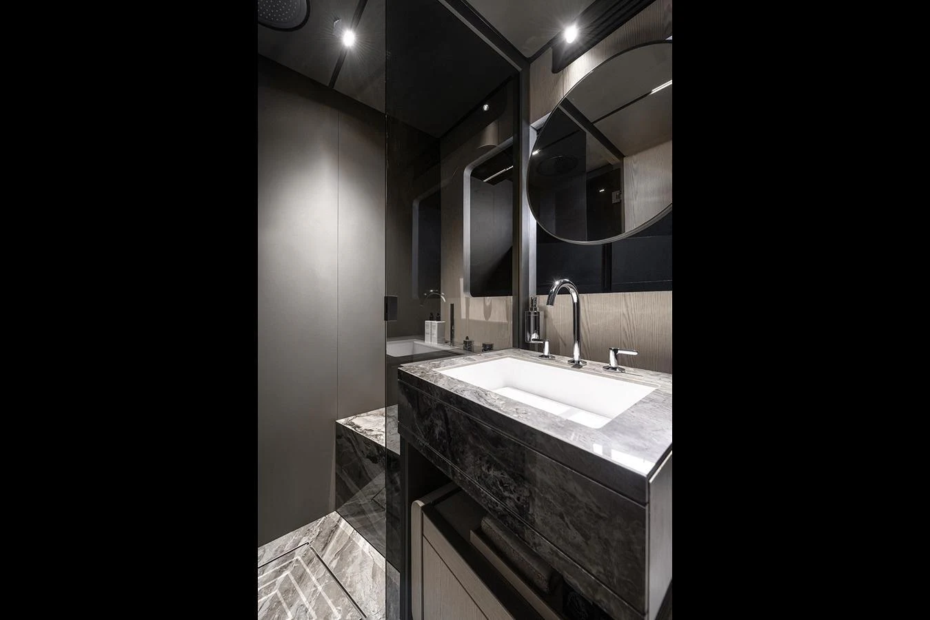 A sleek and modern yacht bathroom with elegant fixtures and a luxurious marble countertop. aboard INFYNITO 80 Yacht for Sale