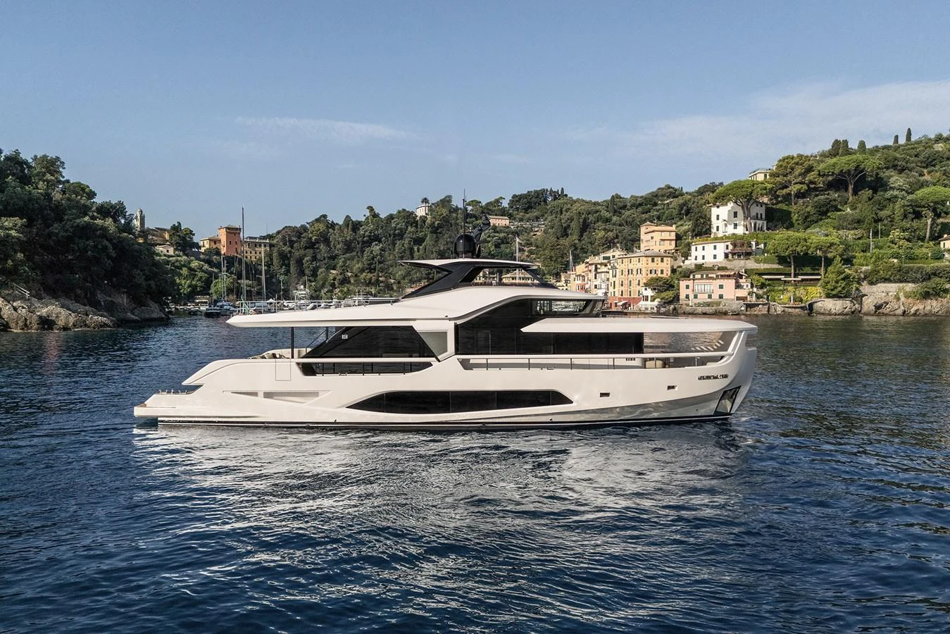 A sleek and modern yacht cruising in a picturesque coastal setting. aboard INFYNITO 80 Yacht for Sale
