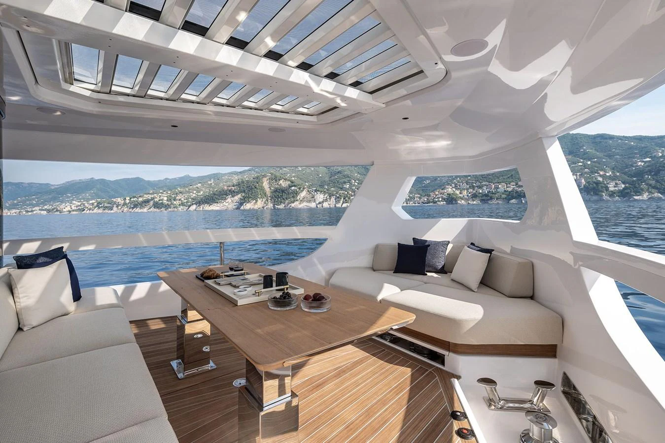 The yacht's salon offers a luxurious and spacious seating area with panoramic views of the surrounding waters. aboard INFYNITO 80 Yacht for Sale