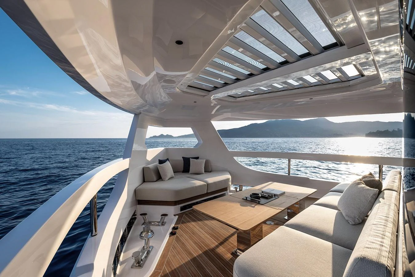 The aft deck offers a luxurious outdoor seating area with panoramic ocean views. aboard INFYNITO 80 Yacht for Sale