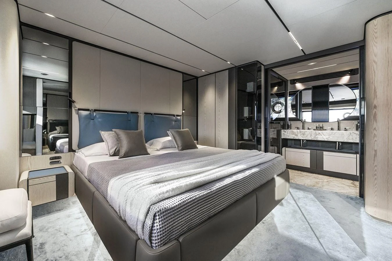 The master stateroom features a luxurious bed with modern decor and an ensuite bathroom. aboard INFYNITO 80 Yacht for Sale