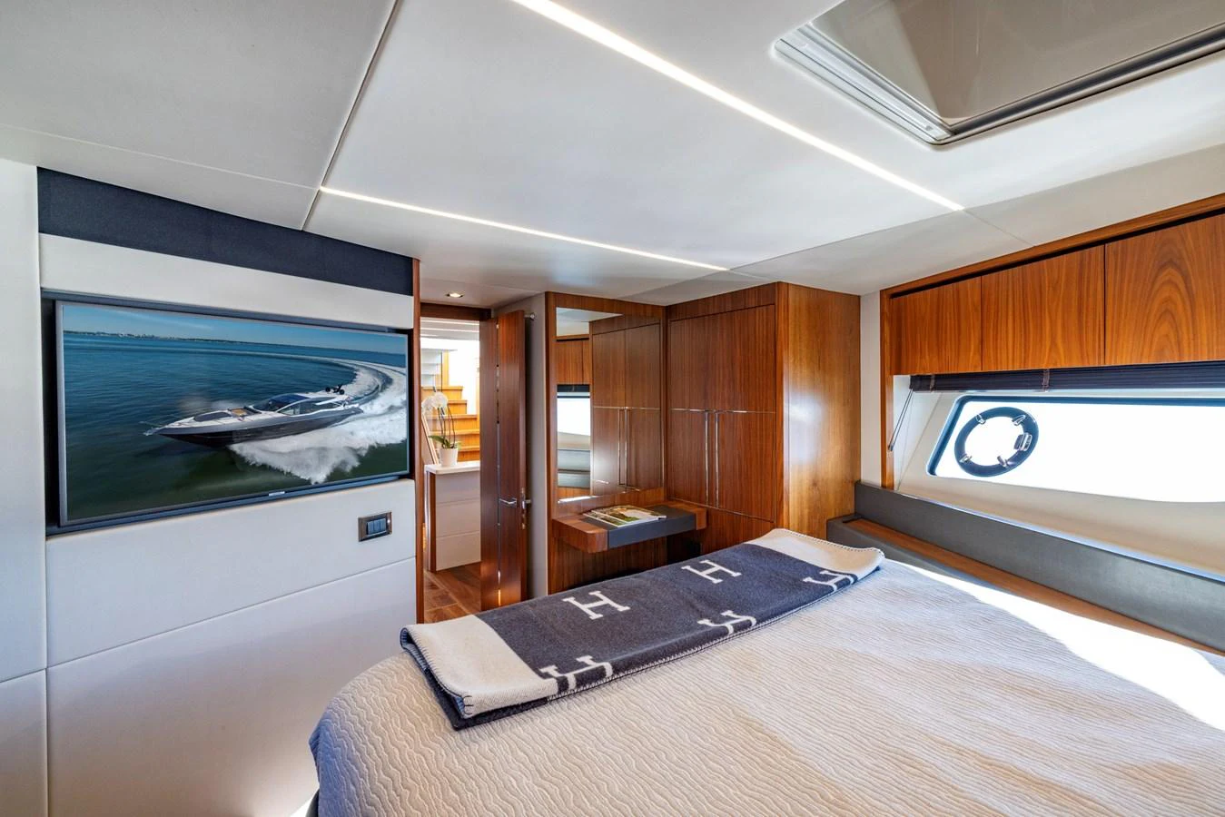 a bedroom with a large tv aboard KB JR Yacht for Sale