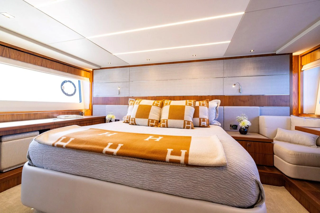 a bedroom with a bed and a couch aboard KB JR Yacht for Sale