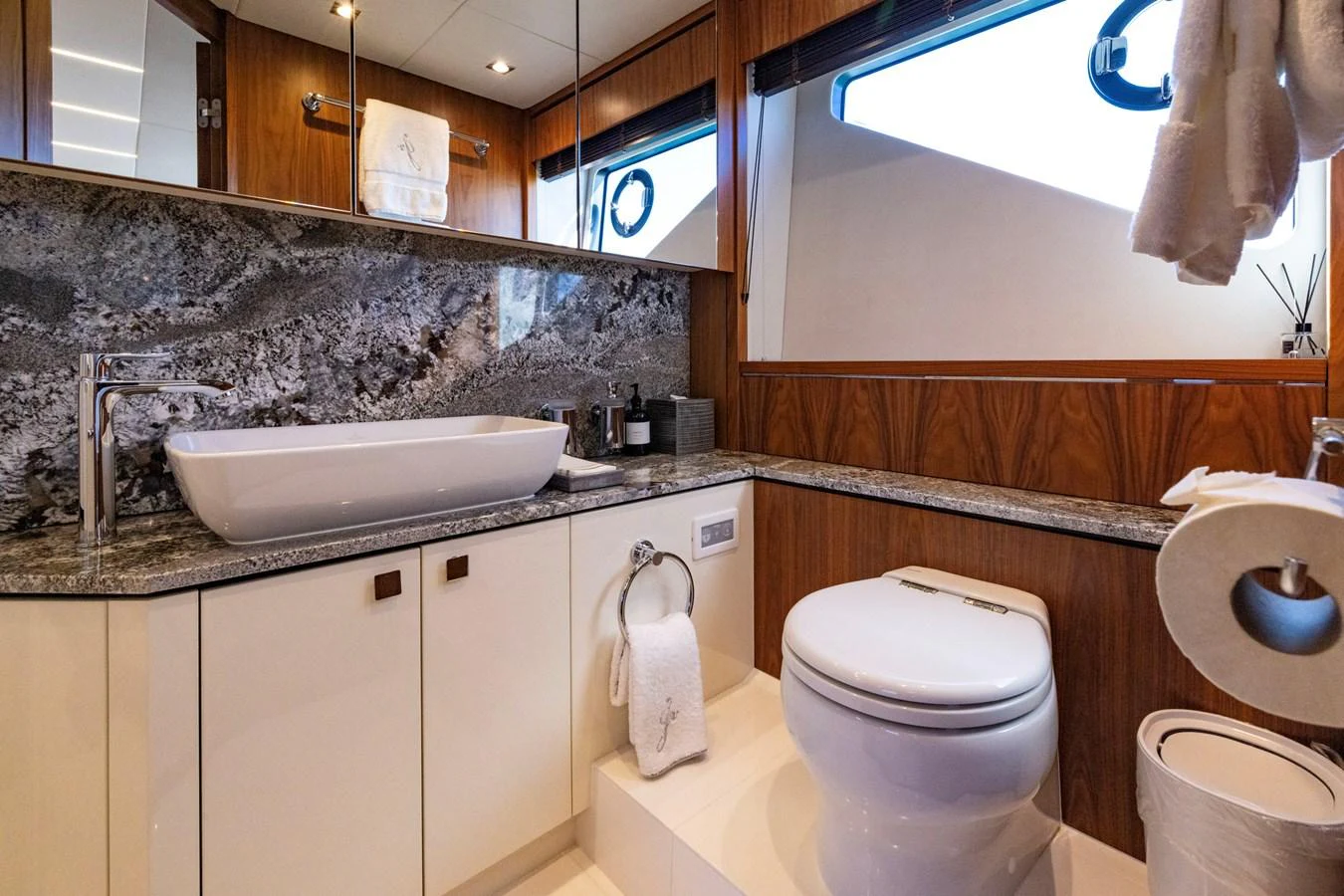 a bathroom with a sink toilet and a mirror aboard KB JR Yacht for Sale