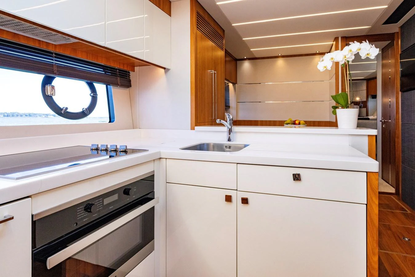 a kitchen with white cabinets aboard KB JR Yacht for Sale