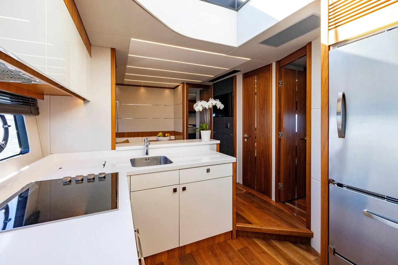 a kitchen with wooden cabinets aboard KB JR Yacht for Sale