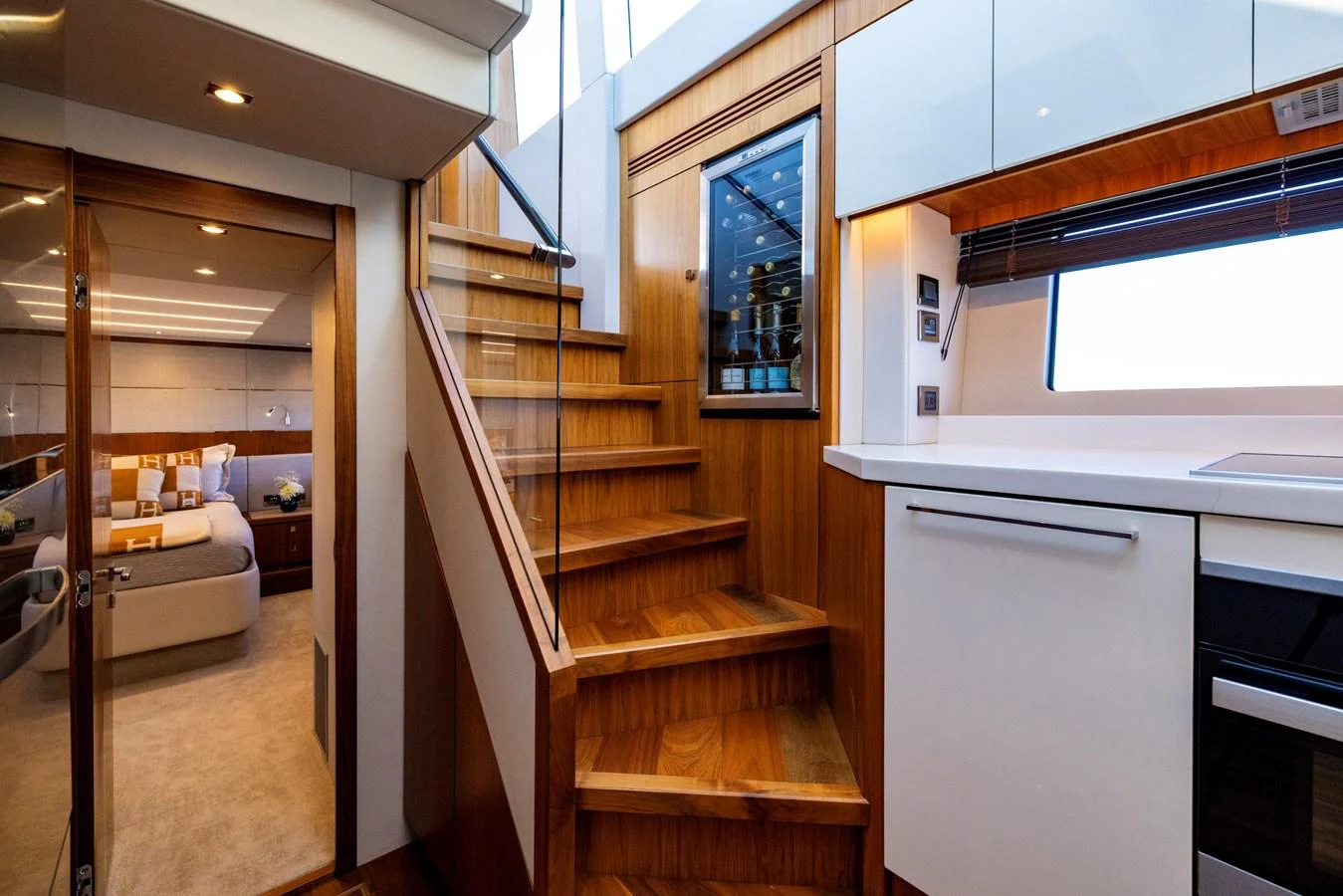 a room with a wood staircase and a white refrigerator aboard KB JR Yacht for Sale