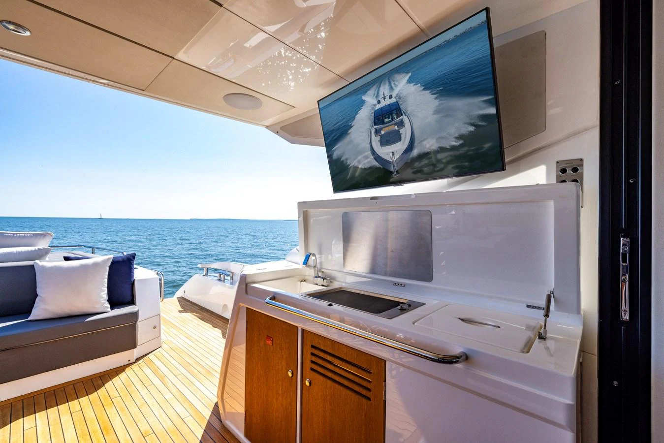 a room with a large television and a bed aboard KB JR Yacht for Sale