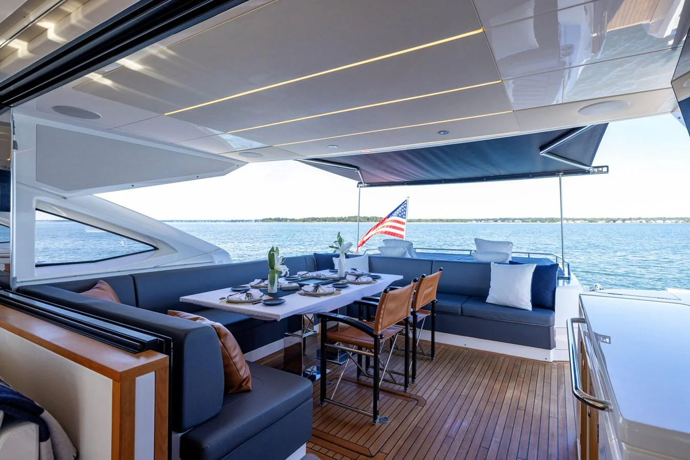 a boat with a table and chairs aboard KB JR Yacht for Sale