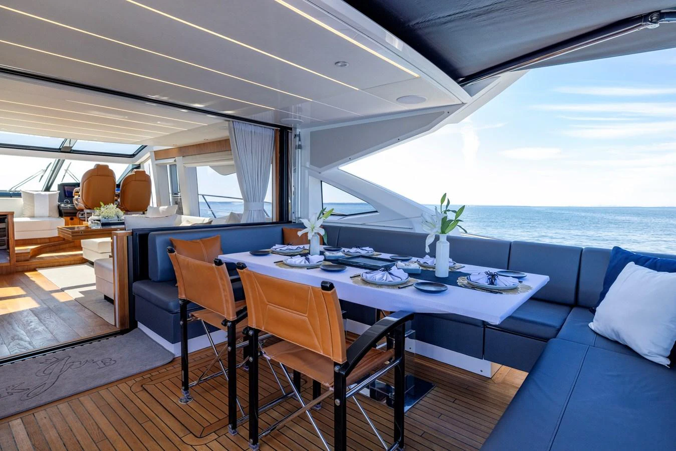 a large room with a table and chairs aboard KB JR Yacht for Sale