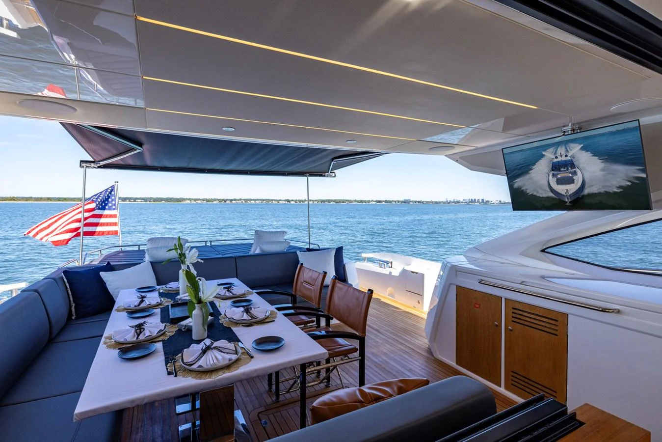 a large boat with a table and chairs on it aboard KB JR Yacht for Sale