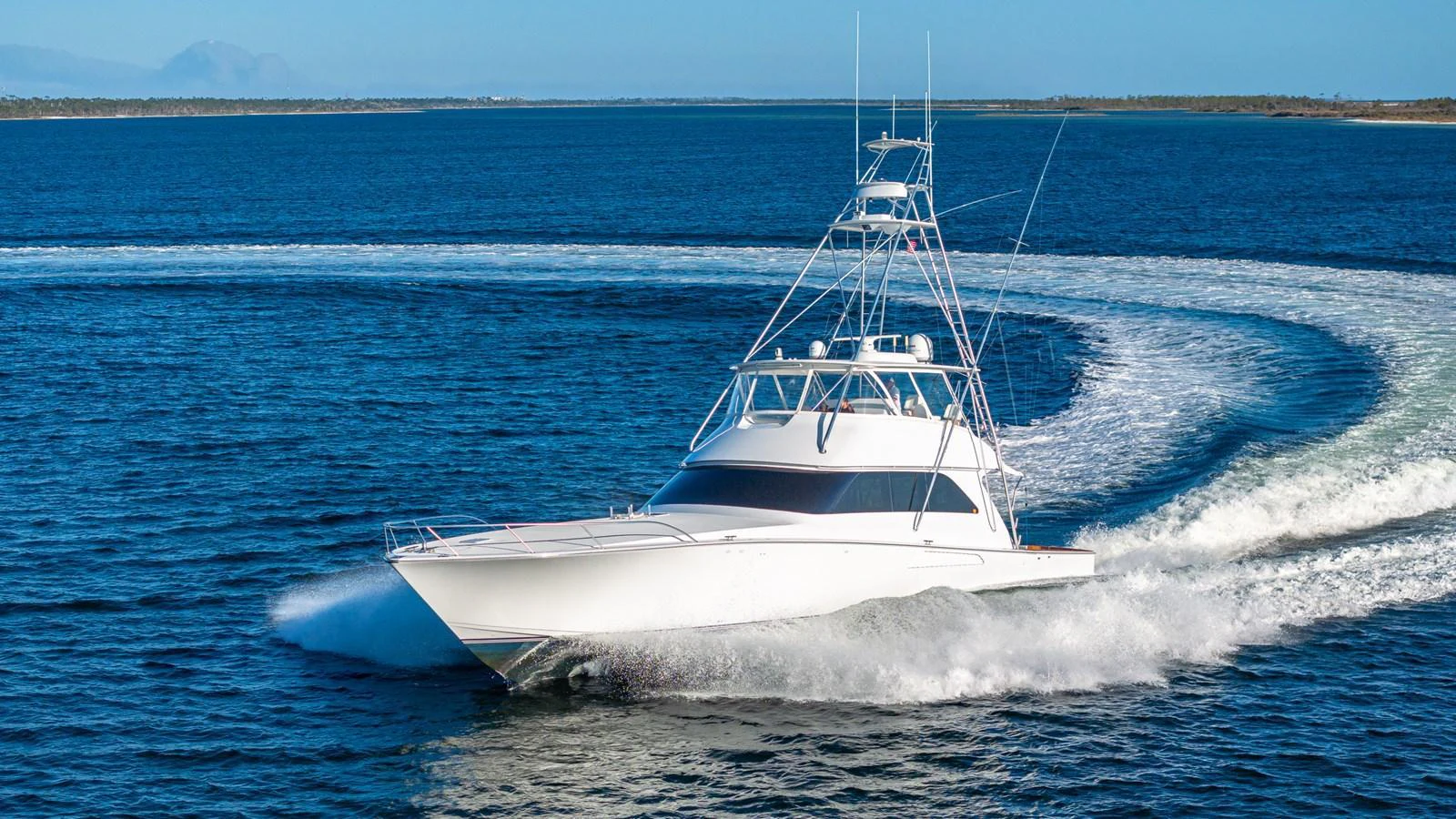 A sleek yacht cuts through the water, showcasing its impressive speed and agility. aboard FIRST BITE Yacht for Sale