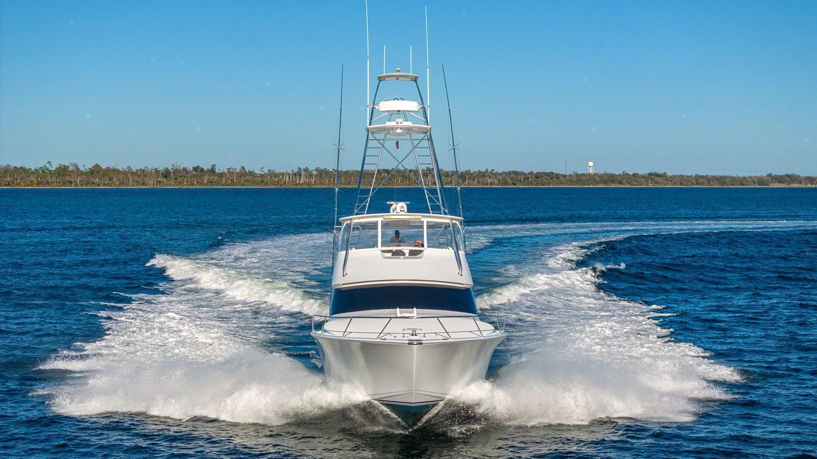 A sleek yacht cuts through the water, showcasing its powerful performance. aboard FIRST BITE Yacht for Sale