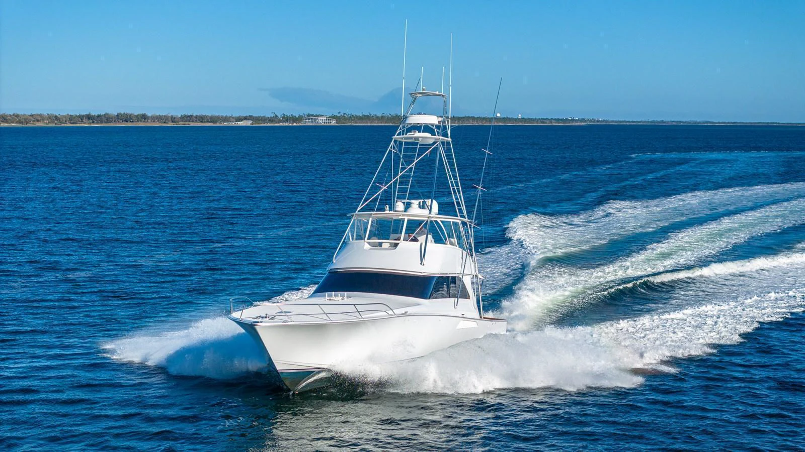 A sleek yacht cuts through the water at high speed, showcasing its powerful performance. aboard FIRST BITE Yacht for Sale
