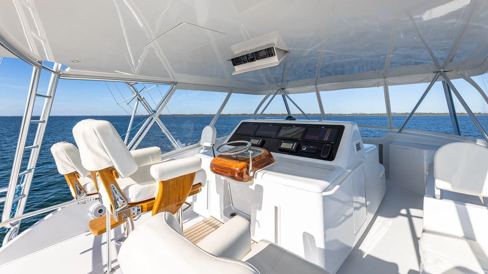 The helm station offers a commanding view with modern navigation equipment and comfortable seating. aboard FIRST BITE Yacht for Sale