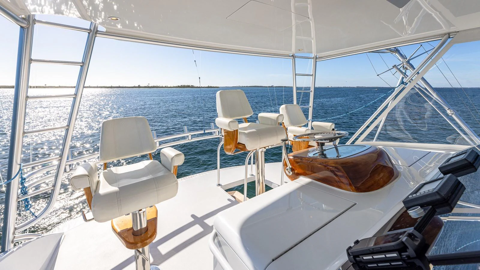 The flybridge offers a panoramic view with comfortable seating and state-of-the-art navigation equipment. aboard FIRST BITE Yacht for Sale