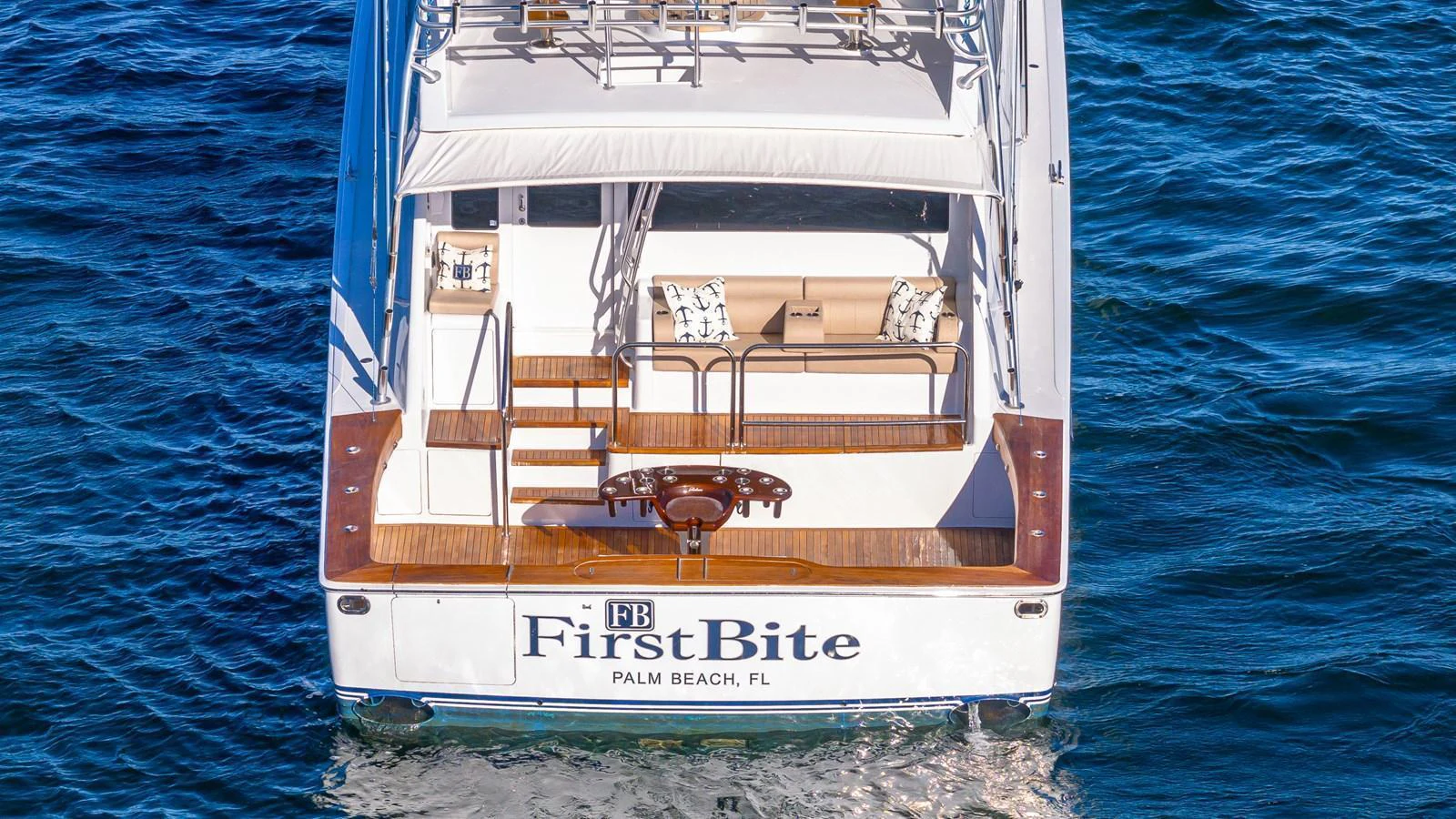 The aft deck of this yacht features a comfortable seating area with a view of the water. aboard FIRST BITE Yacht for Sale