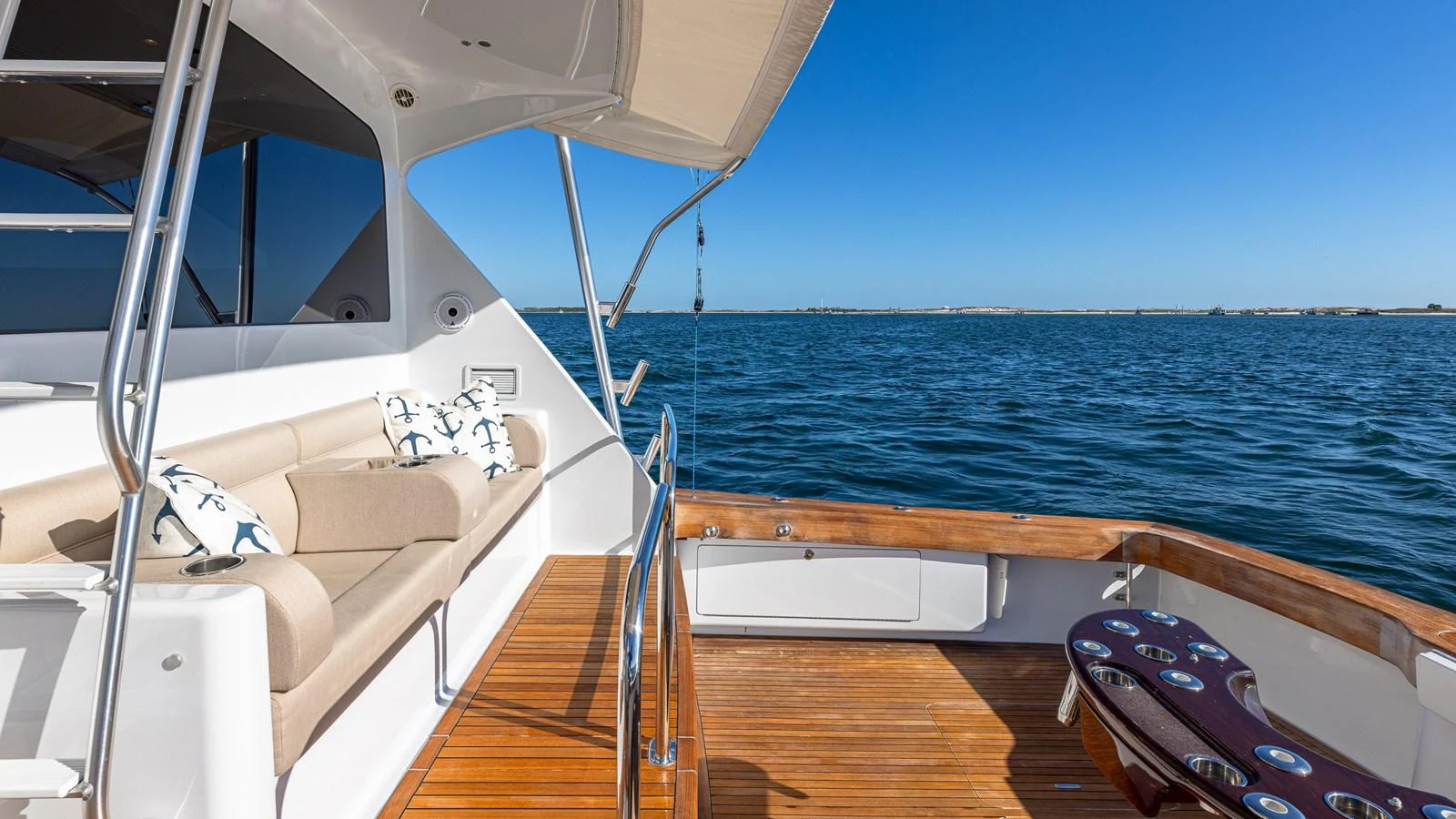 The aft deck offers a comfortable seating area with a stunning view of the open water. aboard FIRST BITE Yacht for Sale