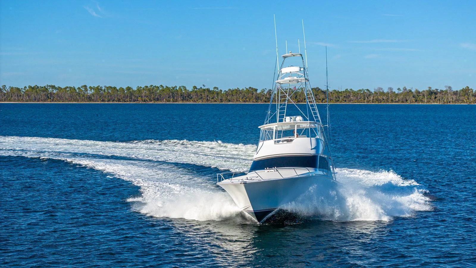 A sleek yacht cuts through the water, showcasing its powerful performance and elegant design. aboard FIRST BITE Yacht for Sale