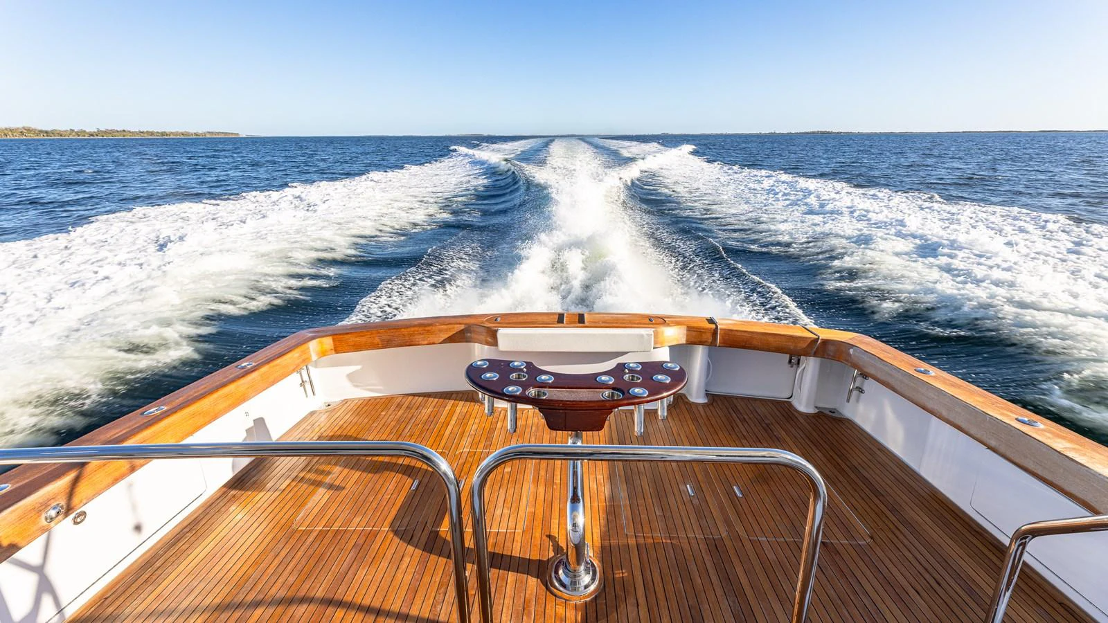 The aft deck offers a stunning view of the yacht's wake as it cruises through open waters. aboard FIRST BITE Yacht for Sale