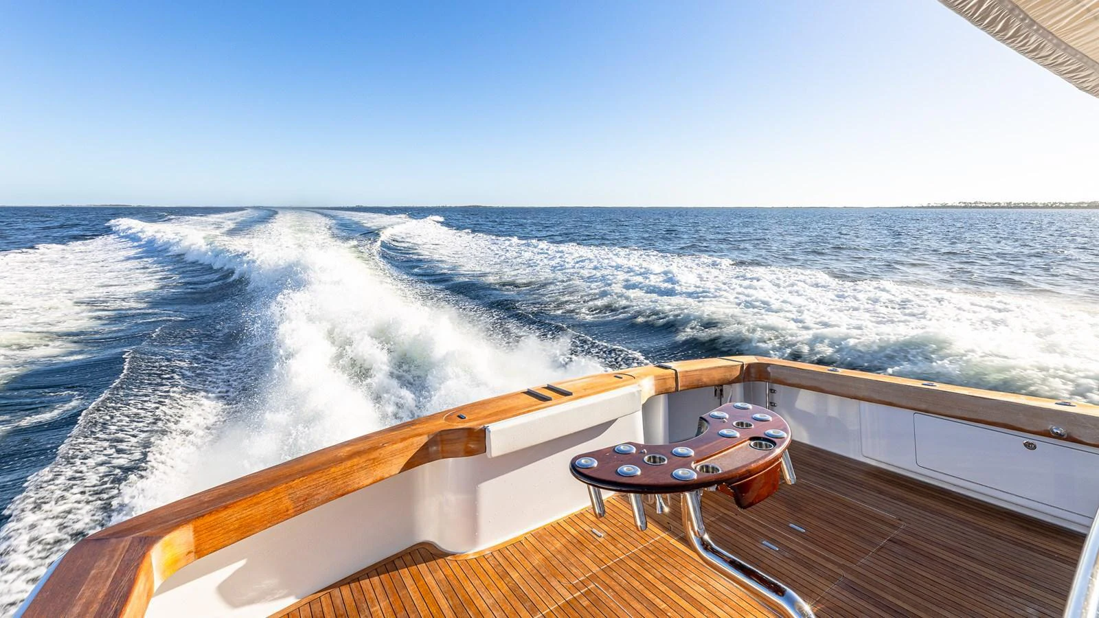 The aft deck offers a stunning view of the yacht's wake as it cruises through the water. aboard FIRST BITE Yacht for Sale